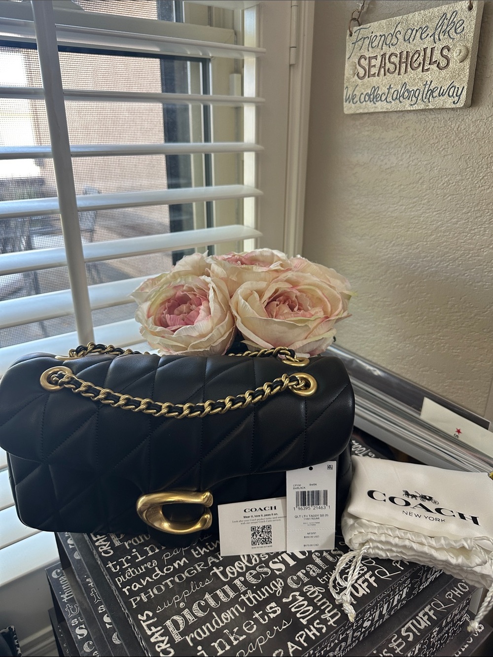 Coach Quilted Tabby 26 in black leather with gold hardware.